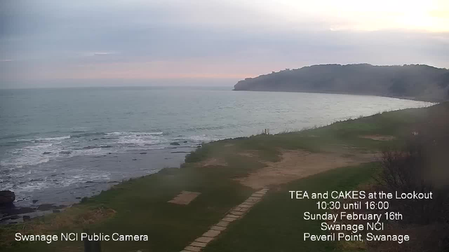 A coastal scene with gentle waves lapping at the shore. The ocean is a muted blue-green color under a cloudy sky with soft gray tones. In the foreground, a grassy area leads to a path made of stone slabs that disappears into the distance. There is a cliff line in the background, with trees outlining its edge. The left side of the image contains text promoting a tea and cakes event, providing details about the time and location.