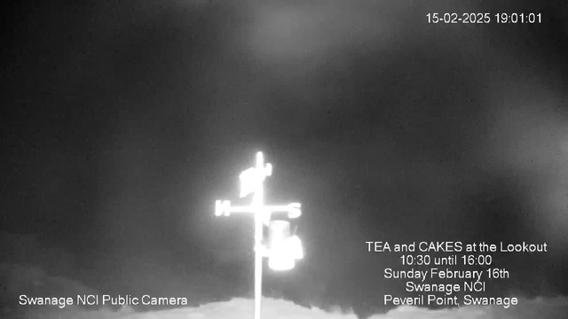 A black and white image of a cloudy sky with a visible compass rose indicating north, south, east, and west. Below the compass, there is text advertising an event titled "TEA and CAKES at the Lookout," specifying the date and time as Sunday, February 16th, from 10:30 to 16:00, located at Swanage NCI, Peveril Point, Swanage.