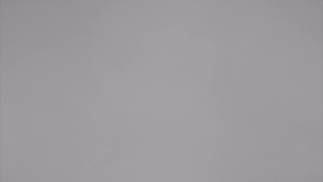 A plain gray surface with a uniform color and no distinct features or patterns. The image is devoid of any objects or subjects, providing a flat, featureless background.