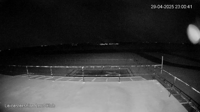 A black and white webcam image showing a mostly empty outdoor tennis court enclosed by a fence. The scene is dark, indicating it is nighttime. The top right corner displays the date and time as 29-04-2025 23:00:41. The bottom left corner has the text "Leicestershire Aero Club."