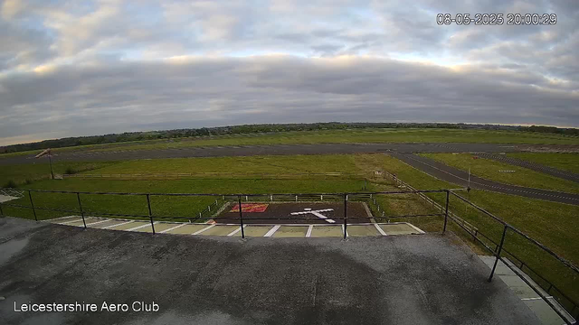 An outdoor view from a webcam at Leicesterhire Aero Club showing a cloudy sky over a grassy field with runways and taxiways in the background. The image is timestamped "08-05-2025 20:00:29" and the location is marked in the bottom left corner.