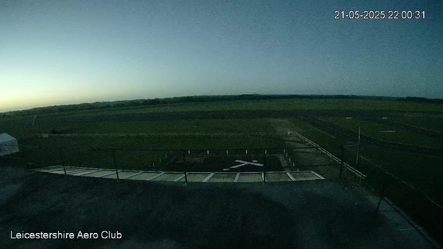 An empty racetrack at dusk with a clear sky, distant horizon, and a timestamp in the top right corner showing "21-05-2025 22:00:31." The bottom left corner has the text "Leicestershire Aero Club."