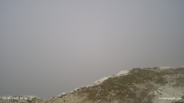 A foggy scene on a mountain or coastal area with limited visibility. The foreground shows a rocky, uneven surface with patches of white, possibly snow or salt deposits. The background is obscured by thick fog, making it impossible to see beyond the immediate area. The timestamp on the bottom left corner indicates the date and time as May 31, 2025, at 11:00:32.