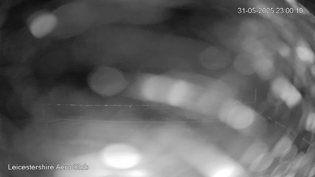 A blurry, black-and-white close-up of a surface with circular light reflections and some indistinct shapes. The image appears to be taken from a webcam, with the timestamp "31-05-2025 23:00:10" in the top right corner, and the text "Leicestershire Aero Club" in the bottom left corner.