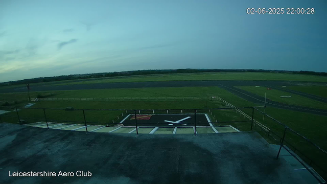A wide view of an airfield shows a landing strip, a helicopter pad, and surrounding grassy areas under a cloudy sky. The image is timestamped June 2, 2025, at 10:00 PM. The location is identified as Leicestershire Aero Club.
